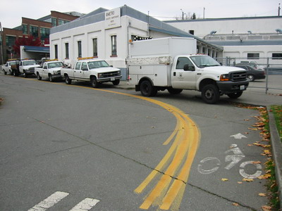 County vehicles park in bike lane