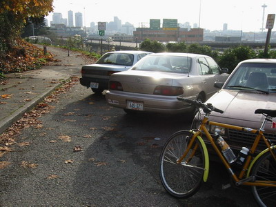 Parked cars block access to bike path
